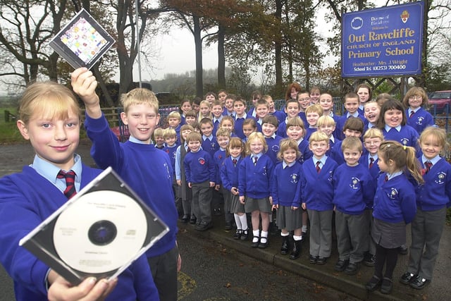 Children from Out Rawcliffe Primary School with their CD which is being sold to raise money for a school extension. The kids will also be singing on radio Lancashire. Pictured from left right, holding the CDs are Linda Wood, 10, and Philip Brown, 11, watched by their fellow classmates