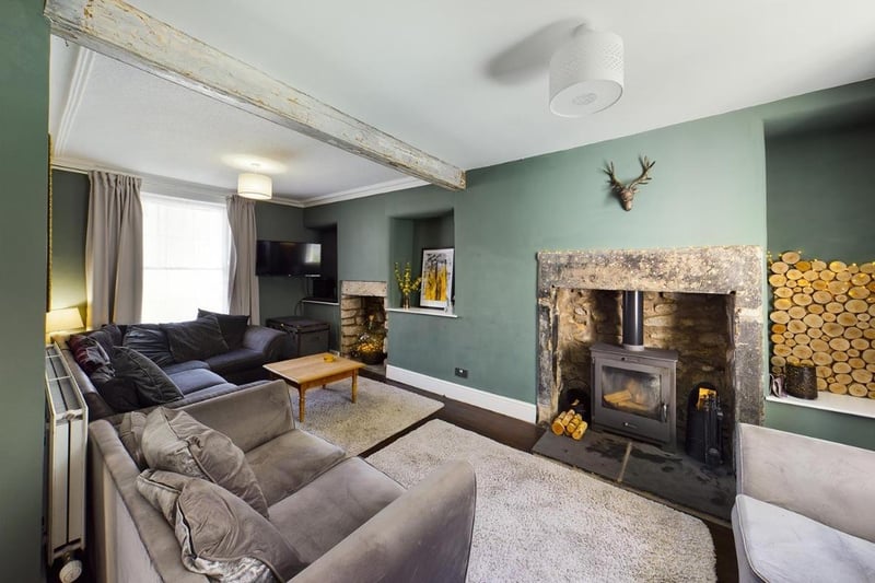 The lounge features a beautiful stone surround fireplace with inset multi-fuel stove and another feature fireplace to the front which is currently unused, original coving and oak flooring.
