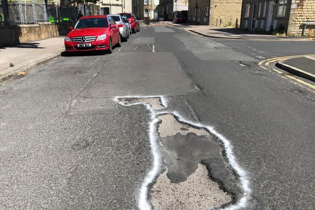 Potholes on Poulton Road, Morecambe, have been circled with chalk to highlight them.