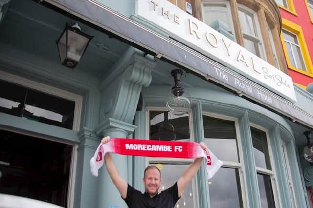 Leaseholder Chris Donaldson with a Morecambe FC scarf after The Royal Bar and Shaker partnered with Morecambe FC for away fans. Picture from Morecambe FC.