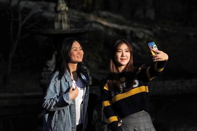 Shin Hu and Cindy Zhang take a selfie in the sunshine in Williamson Park in 2019.