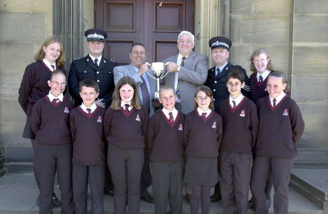 Morecambe High School pupils with headteacher Steve Allott receive the Lancashire Partnership Against Crime (LANPAC) Millennium Trophy presented by Inspector Steve Watson, Sgt Dal Dawkins and Ian Groundwater of LANPAC.