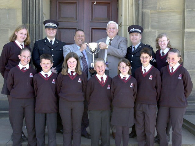 Morecambe High School pupils with headteacher Steve Allott receive the Lancashire Partnership Against Crime (LANPAC) Millennium Trophy presented by Inspector Steve Watson, Sgt Dal Dawkins and Ian Groundwater of LANPAC.