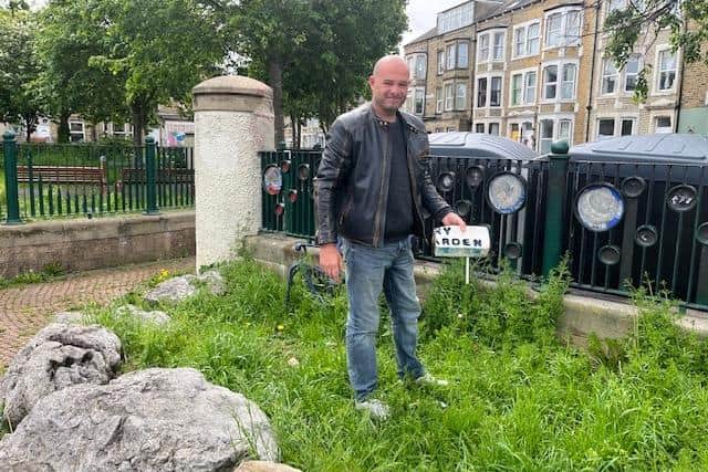 Paul Roberts with the remains of his paddling pool shell which he put in the park to welcome people.