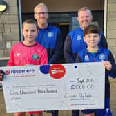 The Lancaster City youth tournament cheque presentation to Rosemere - Alan and Darren at the back with Oliver and Tommy holding the cheque.