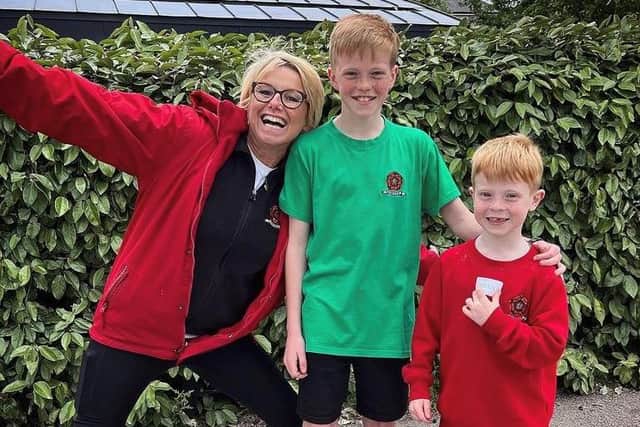 Connor Poole, centre, celebrates his fundraising success with Bowerham School head Joanne Banks and his brother Ethan.
