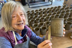 Kathy Cartledge from Bentham Pottery with one of the mugs.