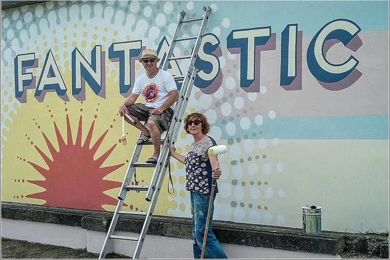 Shane Johnstone and Kate Drummond with their striking new artwork on the old electrical box behind the Midland.