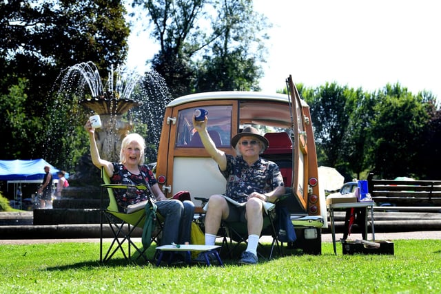Harry and Ellen Moore raise a cuppa outside their campervan at the classic vehicle meet up