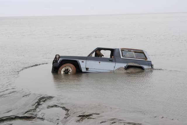 A submerged 4x4 believed to have been used to transport the Chinese cocklers to the cockling beds.