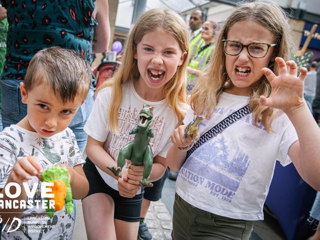 Three children at Dino Fest pretend to be dinosaurs. Picture by Ginny Koppenhol.