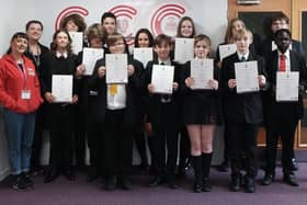 The pupils with their arts awards alongside Rhian Spence and Rachel Parsons from More Music.