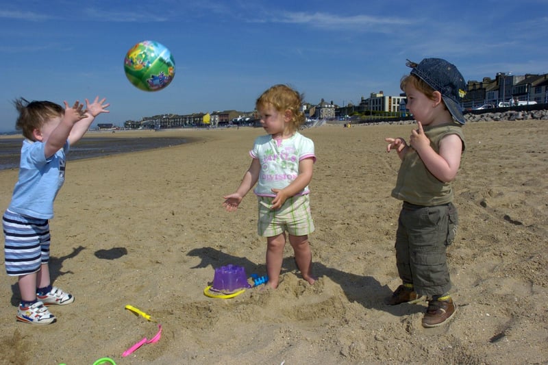 Twins Jacob and Alexander Morgan with their friend Abigail Dudfield enjoying the hot weather on Morecambe beach in 2009.