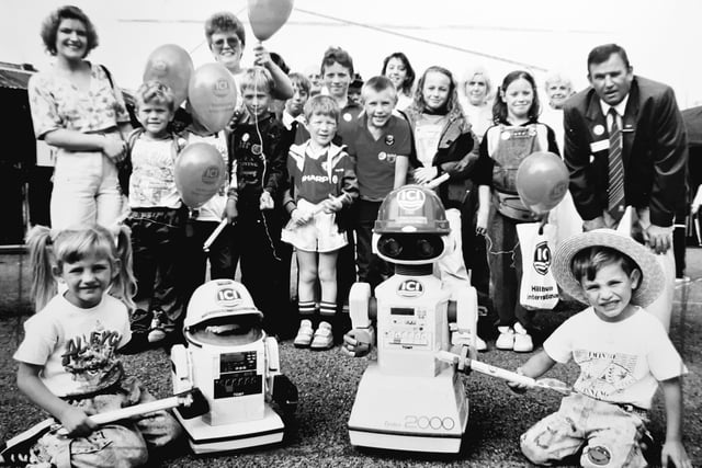 ICI hosted a weekend of centenary celebrations in 1990 to show 15,000 visitors around the site. Twins Kaylee and Dean Stockwell, of Fleetwood, are pictured receiving sticks of rock from ICI's two mini robots