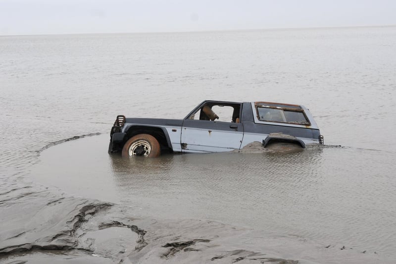 A submerged 4x4 believed to have been used to transport the Chinese cocklers on the night of the tragedy, which was revealed by the waters of the River Kent in Morecambe Bay in 2014, 10 years after the disaster.