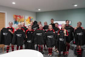 Morecambe Girls Under 11s with their sponsored kit during a tour of the Forget Me Not centre.