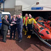 W.M. Bro. Mike Cooke in company with V.W.Bro. Geoff Bury APGM present a cheque to the volunteer crew members at the Morecambe RNLI Lifeboat Station.