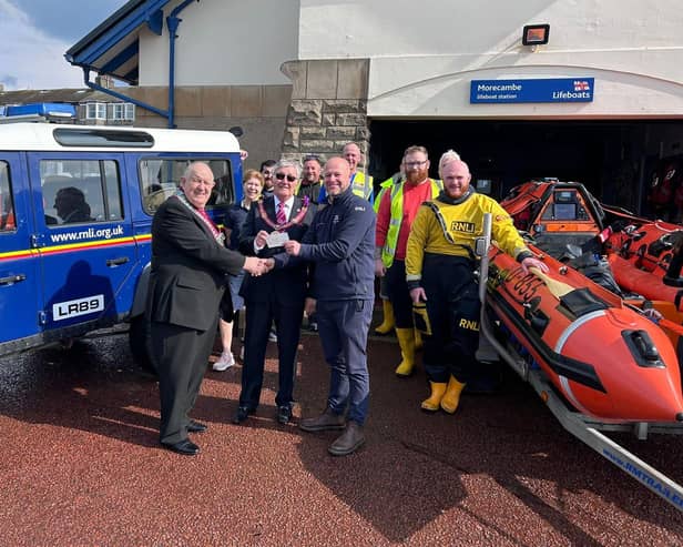 W.M. Bro. Mike Cooke in company with V.W.Bro. Geoff Bury APGM present a cheque to the volunteer crew members at the Morecambe RNLI Lifeboat Station.