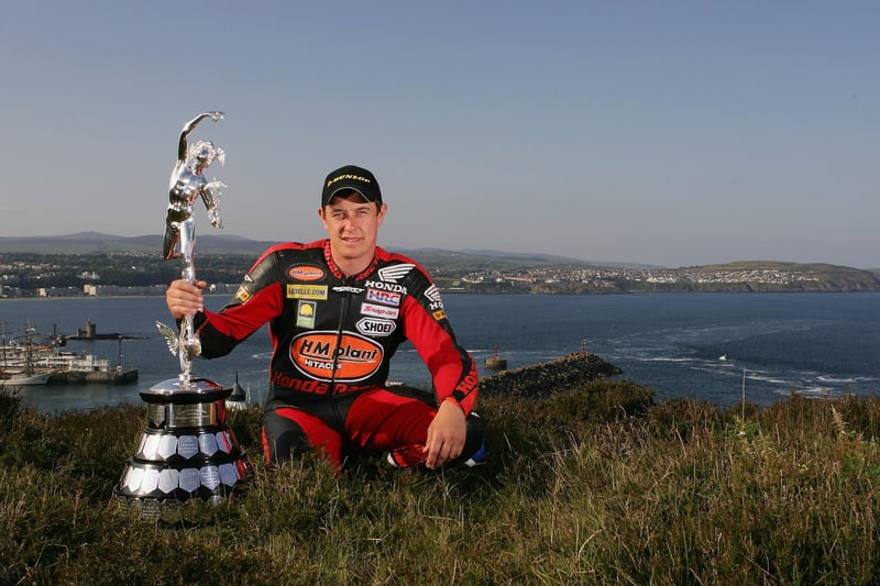 Born and raised in Morecambe, John McGuinness's father owned a motorcycle repair shop, but advised John to train as a bricklayer. Graduating in 1990, the resultant recession forced him into cockle fishing with his future father-in-law. McGuiness's first race was an endurance road race at Aintree in 1990, at age 18. Known as the Morecambe Missile, John is the second most successful TT rider of all time behind the late Joey Dunlop.


poses with the senior trophy during the Isle of Man TT (Tourist Trophy) Races on June 7, 2007 in Douglas, Isle of Man.