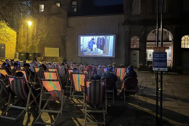 Fifty film-goers relax in deck chairs in Sun Square in Lancaster at the first silent cinema screening in the city.