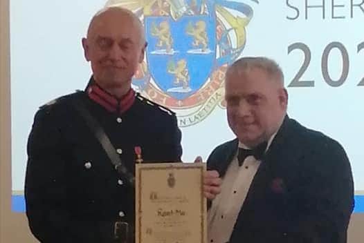 Robert Mee is given his award by the High Sheriff.