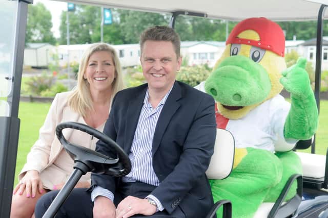 Andrea Challis and Robert Kearsley celebrate the 70th anniversary of Partingtons at Windy Harbour Holiday Park with Grunty the firm's mascot.