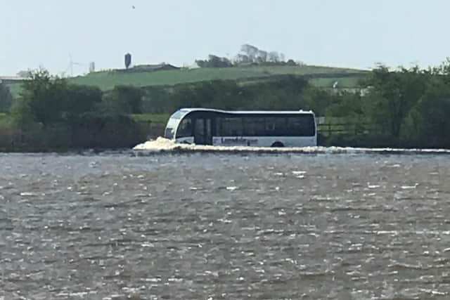 A bus driving through deep water at Glasson. Picture: Sally Maddocks.