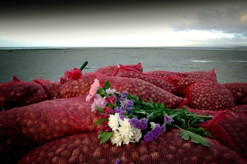 Flowers left in tribute to Chinese cockle pickers who perished in the sea at Morecambe Bay.
