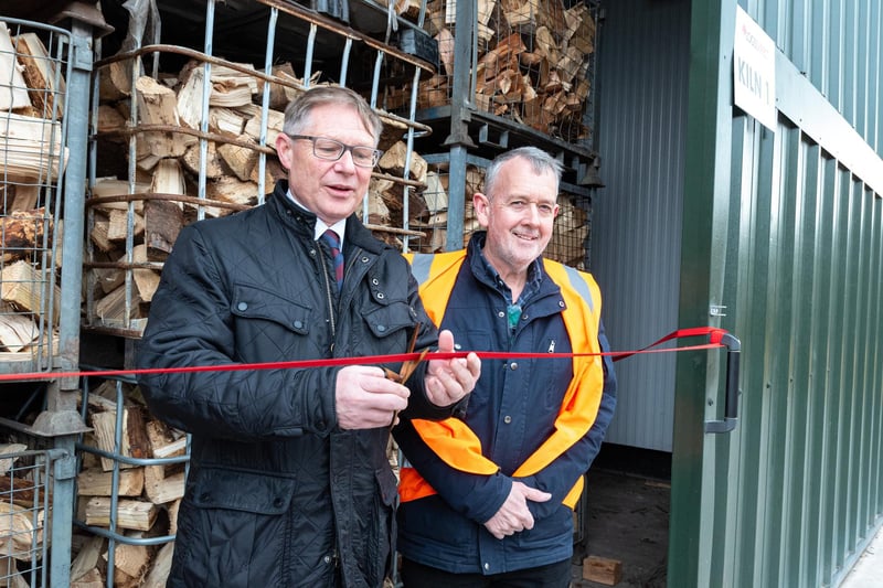 Morecambe MP David Morris cuts the red ribbon with director of Logs Direct, Stephen Talbot, to officially open the new state-of-the-art kiln.