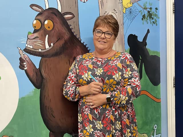 Cathy Armistead, head of Skerton St Luke’s CE Voluntary Aided Primary School, Lancaster, with a mural of the children’s book character The Gruffalo in school.