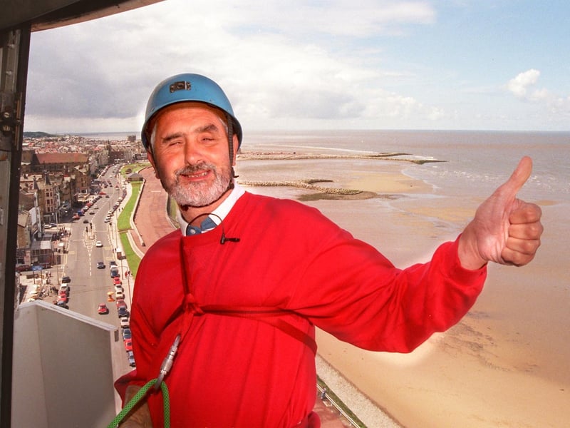 High above Morecambe, Tony Kimpton prepares to abseil down the Polo Tower to raise money for the Blind Society.