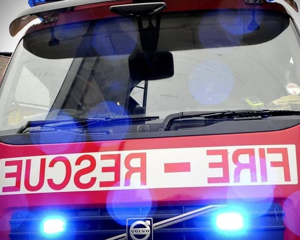Firefighters raced to the scene of an overturned farm vehicle to rescue a person trapped.