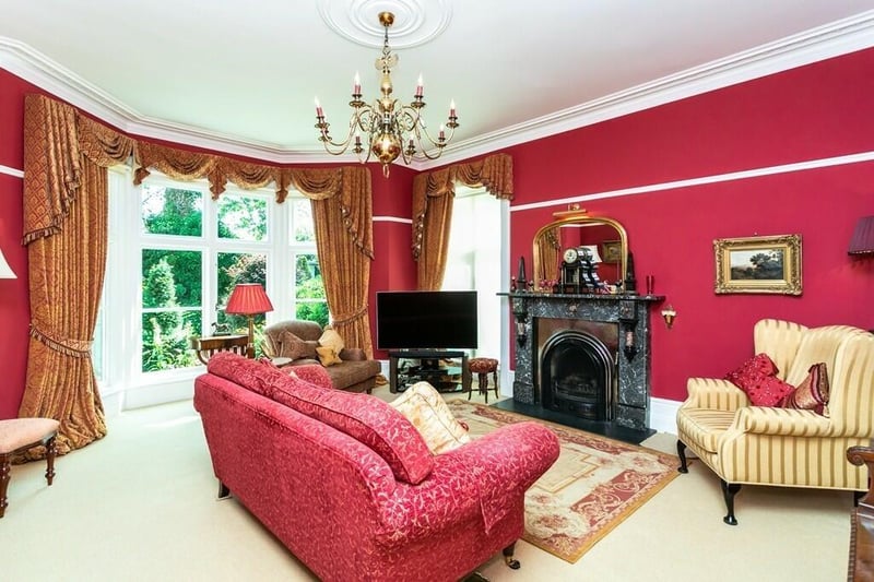 A drawing room with a period fireplace.