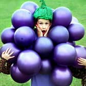 Children at Lytham Hall Park Primary School rounded off their 1997 Book Week activities with a fancy-dress breakfast. Nine-year-old Jonathan Cooper was rather regretting coming dressed as bunch of grapes, when five-year-old Thomas Williams and seven-year-old Samantha Read decided they were still hungry!