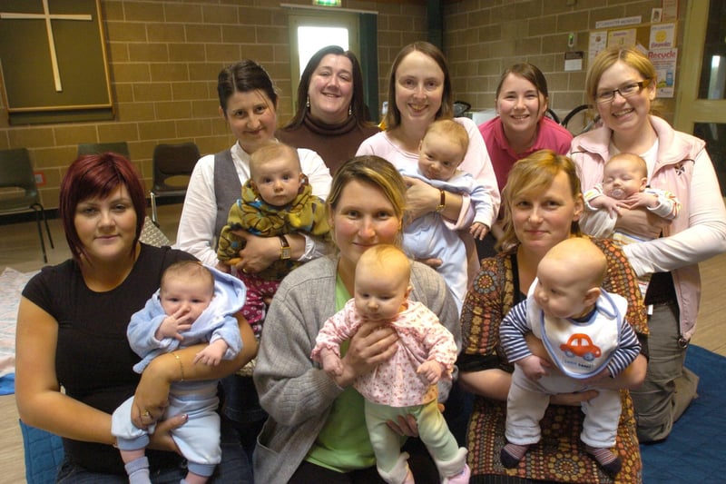 Health visitor Sam Whittle (back left) and outreach worker for Appletree Nursery Karen Hall (back right) with mums and babies at a Baby Massage Class held at Hala Community Centre.