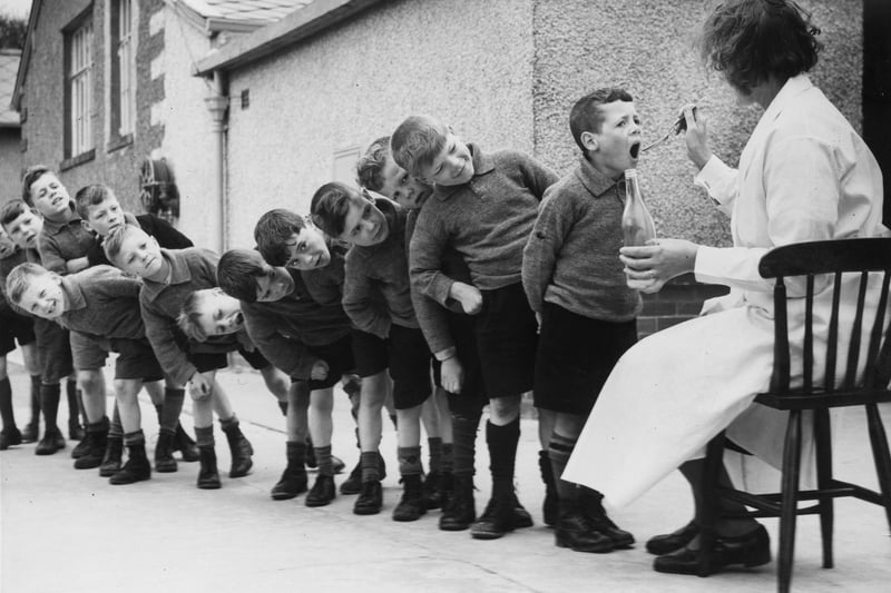 Children from Bradford lining up for a dose of medicine during a holiday at Morecambe.