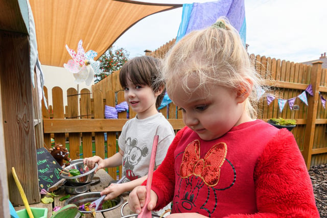 Nursery pupils with vegetables pulled from their new outdoor play area. Photo: Kelvin Stuttard