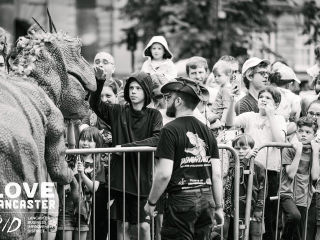 Children pet the dinosaur at Dino Fest at the weekend. Picture by Ginny Koppenhol.