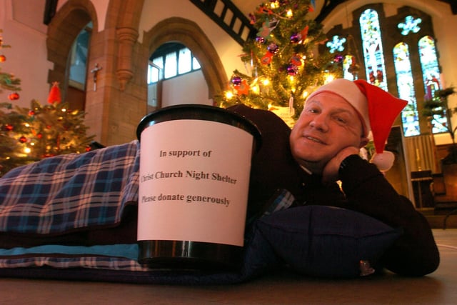 Fundraising the hard way... Vicar Rev Gary Ingram promotes the Christ Church Night Shelter at Morecambe Parish Church's Christmas Tree Festival. (2009).