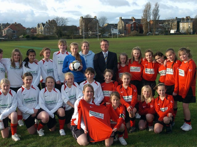 Under 13 and under 15s girls football teams show off their new kit donated by The Football Foundation. Pictured with the girls are teacher/coach Miss Jenny Evans and headteacher Mr John McNaughton.
