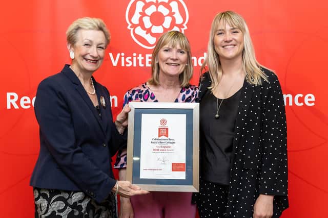 Margaret and Michelle Parry receive their Rose Award certificate from Dame Judith Macgregor, interim chair of the British Tourist Authority Board.