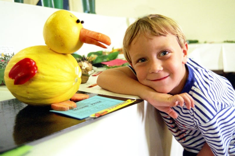 Five-year-old Simon Harrison from Galgate with a bird made from fruit and vegetables by David Bradshaw, at the Galgate Gaslight floral and horticultural society exhibition, which was held in the village institute in Galgate in August 1996.
