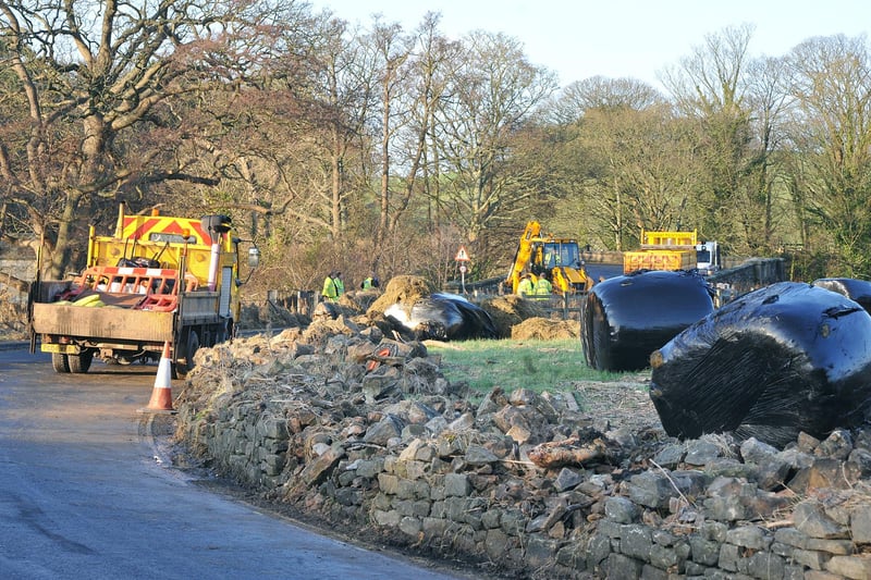 Workers clear Low Road at the Crook O'Lune near Caton which was closed due to flood debris and damage.