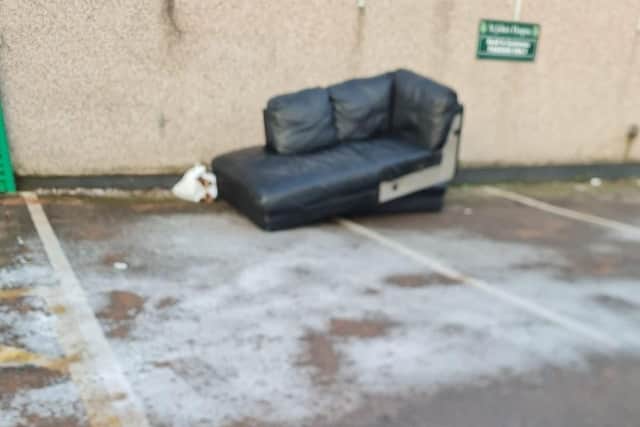 Flytippers dumped a sofa outside a charity shop in Lancaster.