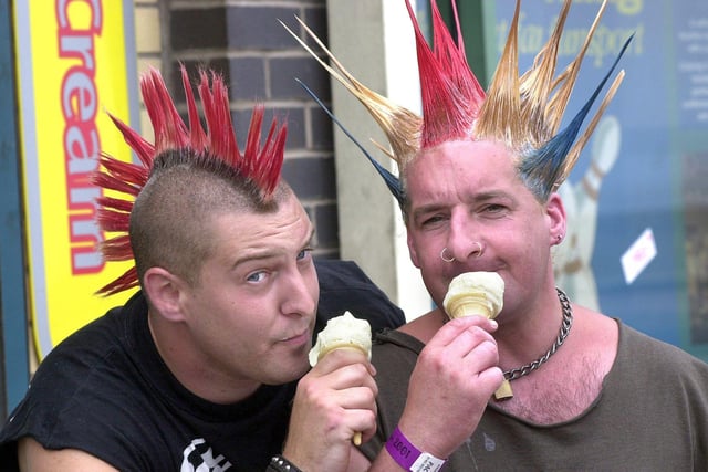 Punks Matt (left) and Ecky from Wiltshire cool off with an ice cream during the 2001 festival.