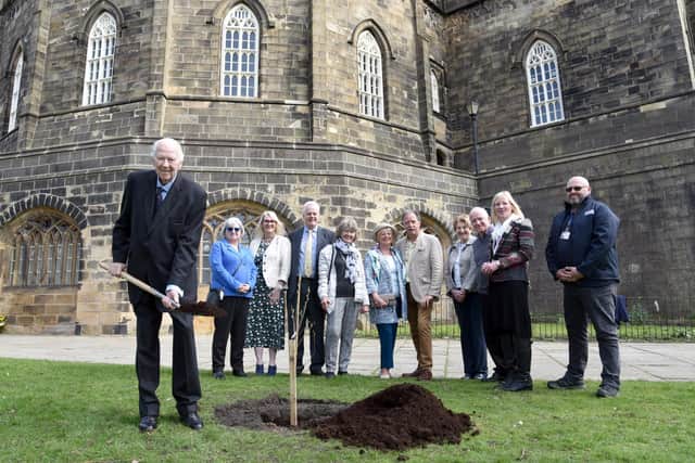 Lord Shuttleworth planting the tree, watched by Pam Barker, Constable of Lancaster Castle, Janet Brimley, chair of Lancashire County Magistrates' Association, magistrate members and Steve Shaw of Lancaster City Council. Photo by Steve Pendrill.
