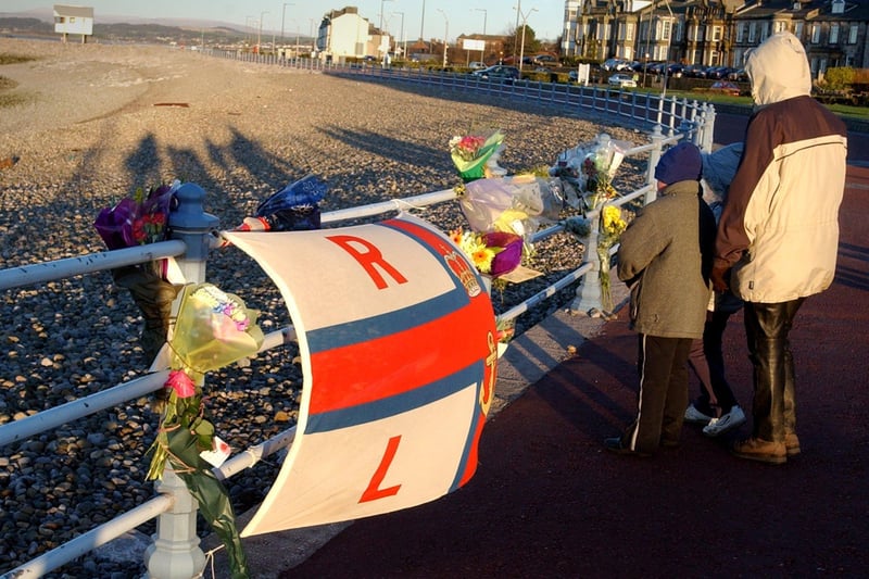 Flowers tied to railings near the RNLI station in Morecambe after the Morecambe Bay cockling tragedy, on the evening of February 5, 2004.