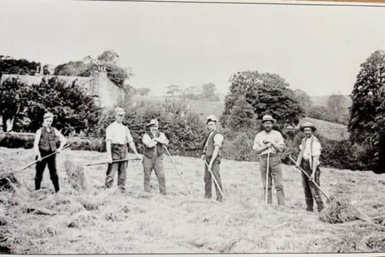 Scaling Hay in the Crofts at Whittington, c.1910. The men would work in a line with each scaling two swathes. The old rectory can be seen in the background. Picture courtesy of David Kenyon.
