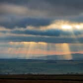 Crepuscular rays shine down on the Forest of Bowland from the moors above Settle