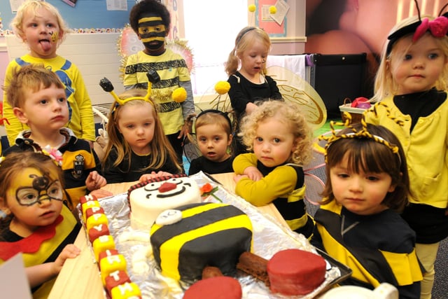Children from Busy Bees Nursery celebrate the 30th birthday of the company with a cake of Buster Bee, made by cook Rob Hanger.